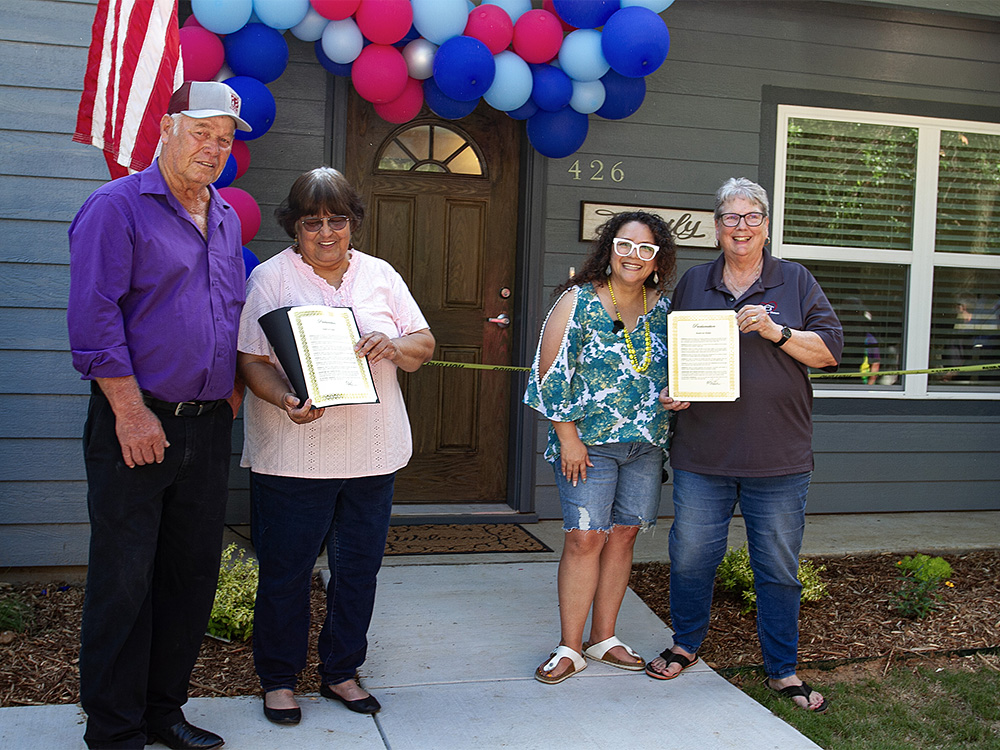 R to L: Mickey and Lupe Hessel, Pilot Point Mayor Elisa Beasley and Hearts for Homes Executive Director Susan Frank participated in the ribbon-cutting ceremony.