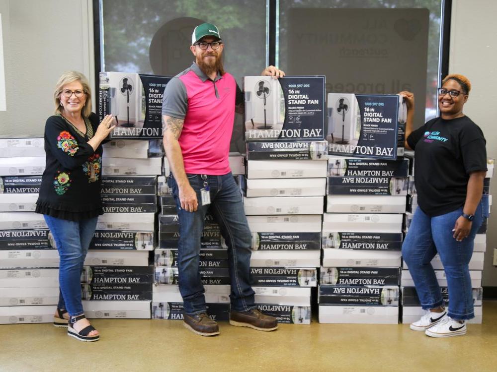 L to R: Staff All Community Outreach, Craig Lay, CoServ Energy Solutions Specialist, Sfaff All Community Outreach. Photo by BRIAN ELLEDGE