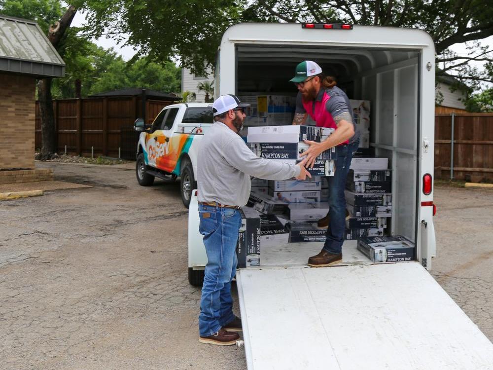 Craig Lay and Jason Cochran from CoServ Energy Efficiency Team delivers fans and A/C units donated by CoServ Charitable Foundation to Community Lifeline Center in McKinney. Photo by BRIAN ELLEDGE