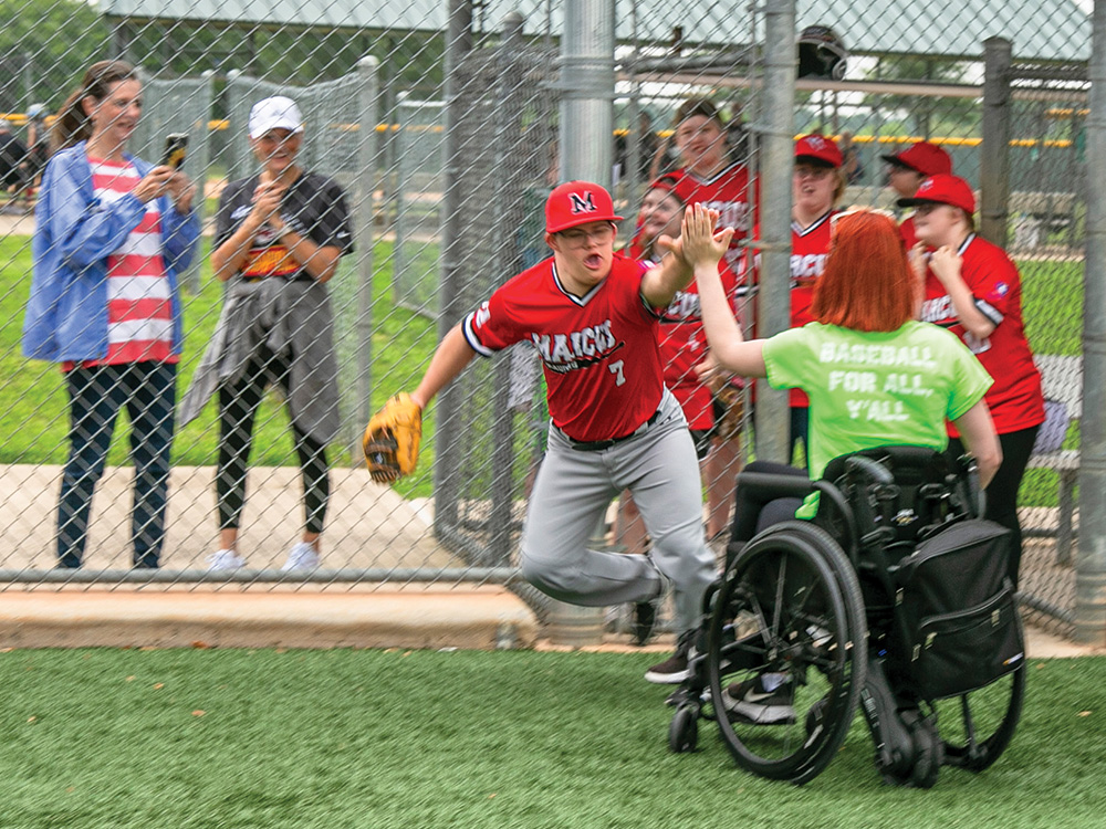 Landon Faulkner gives a high five during player introductions.