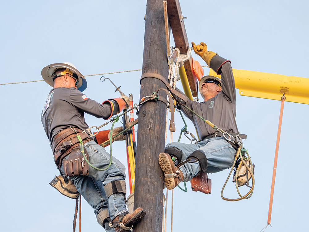 CoServ Crew Supervisor Chris Hammonds and Field Construction Coordinator Alex Garza compete at the Texas Lineman Rodeo in Seguin, Texa