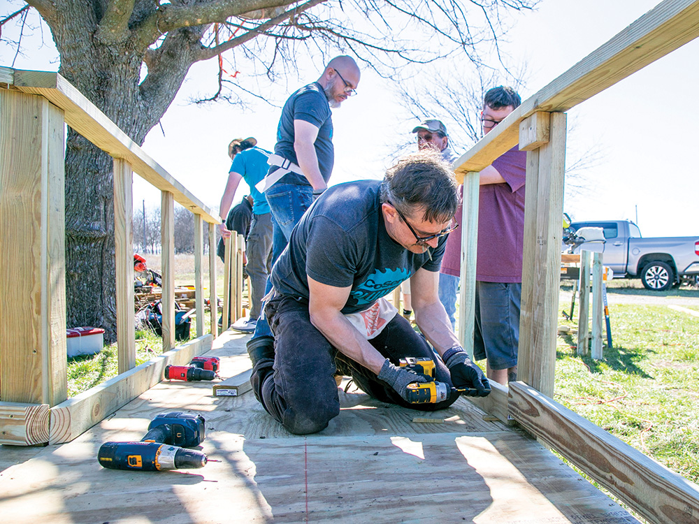 CoServ Employees volunteered to build several ramps this year for the Texas Ramp Project. Photo by NICHOLAS SAKELARIS